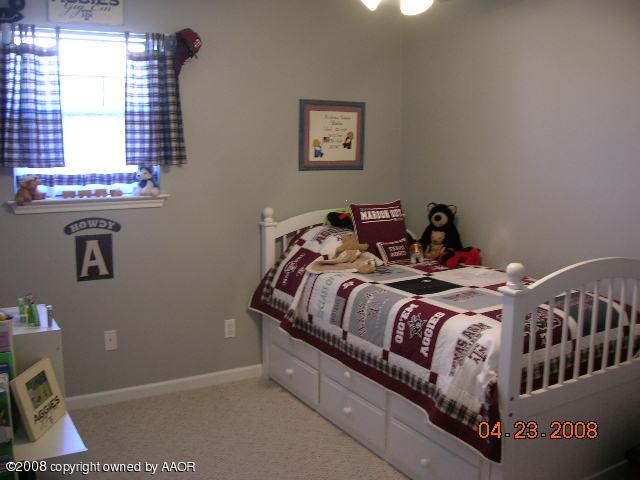 58 Hunsley Road Canyon, TX 79015 - Photo 8 of 10 a bed sitting in a bedroom next to a window