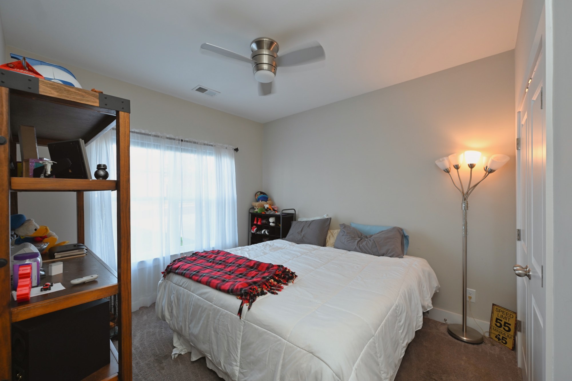 1144 Lock 4 Road, Unit J2 Gallatin, TN 37066 - Photo 8 of 28 a bedroom with a bed and a lamp on the dresser