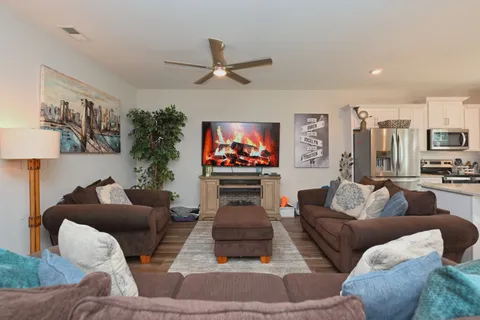 a living room with furniture and a flat screen tv