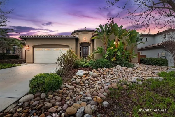 a front view of a house with a yard and a garage