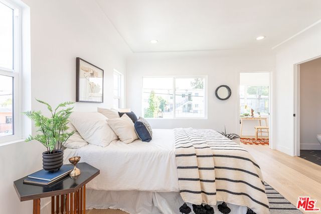 a bedroom with a bed and window
