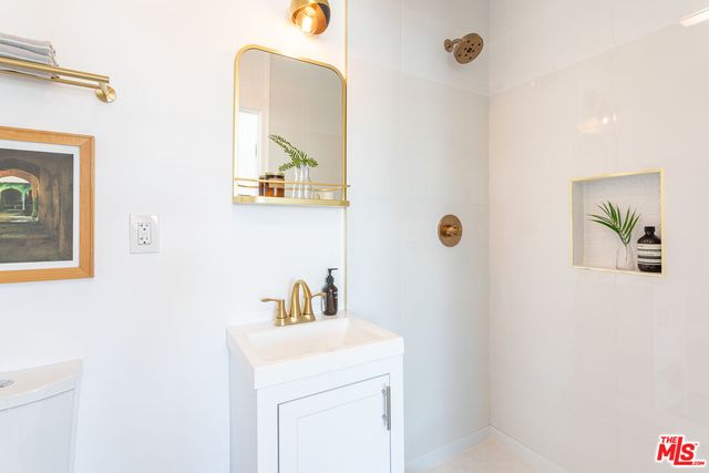 a bathroom with a sink a mirror and vanity