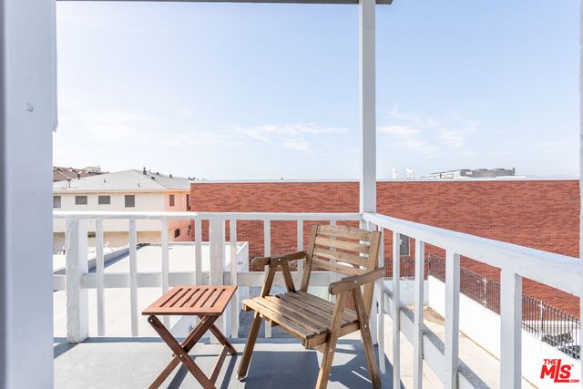 a view of a balcony with chairs