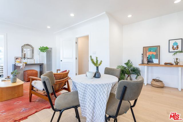 a dining room with furniture and wooden floor