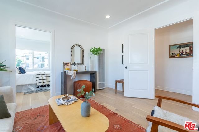 a view of living room with furniture and wooden floor