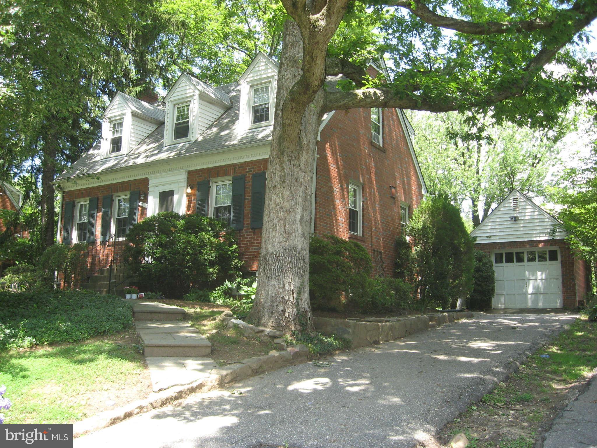 9015 Bradford Road Silver Spring, MD 20901 - Photo 2 of 25 a view of a white house next to a yard with palm trees