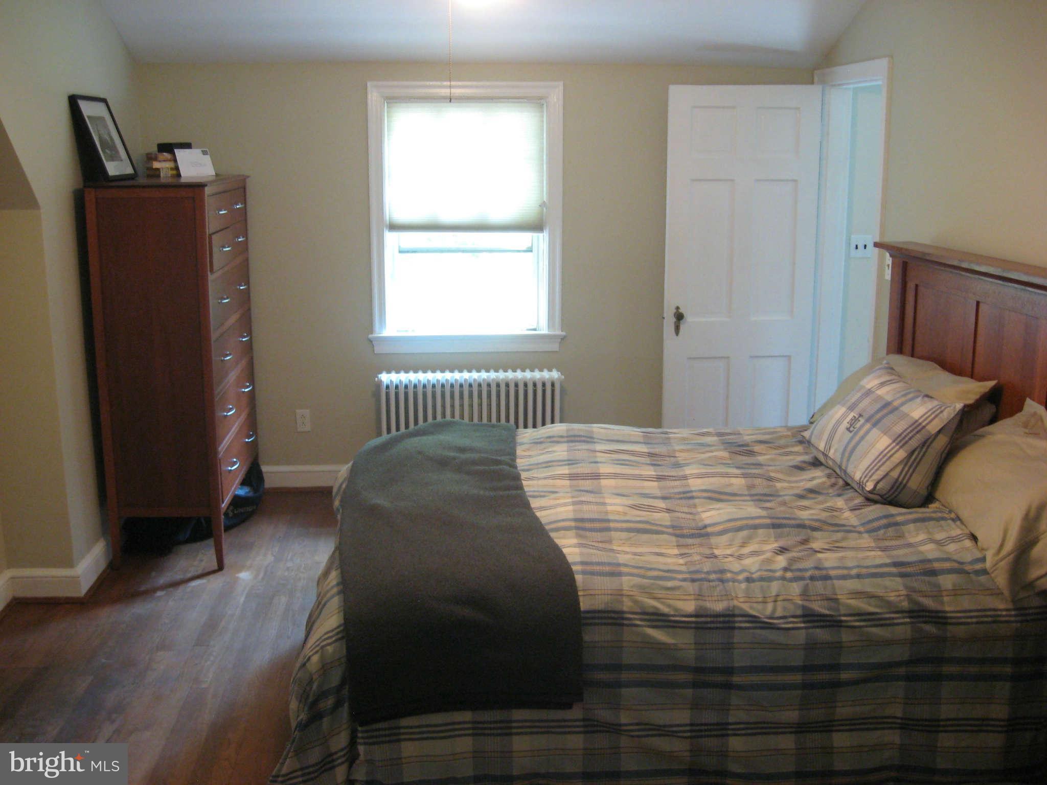 9015 Bradford Road Silver Spring, MD 20901 - Photo 11 of 25 a bedroom with a bed and a window