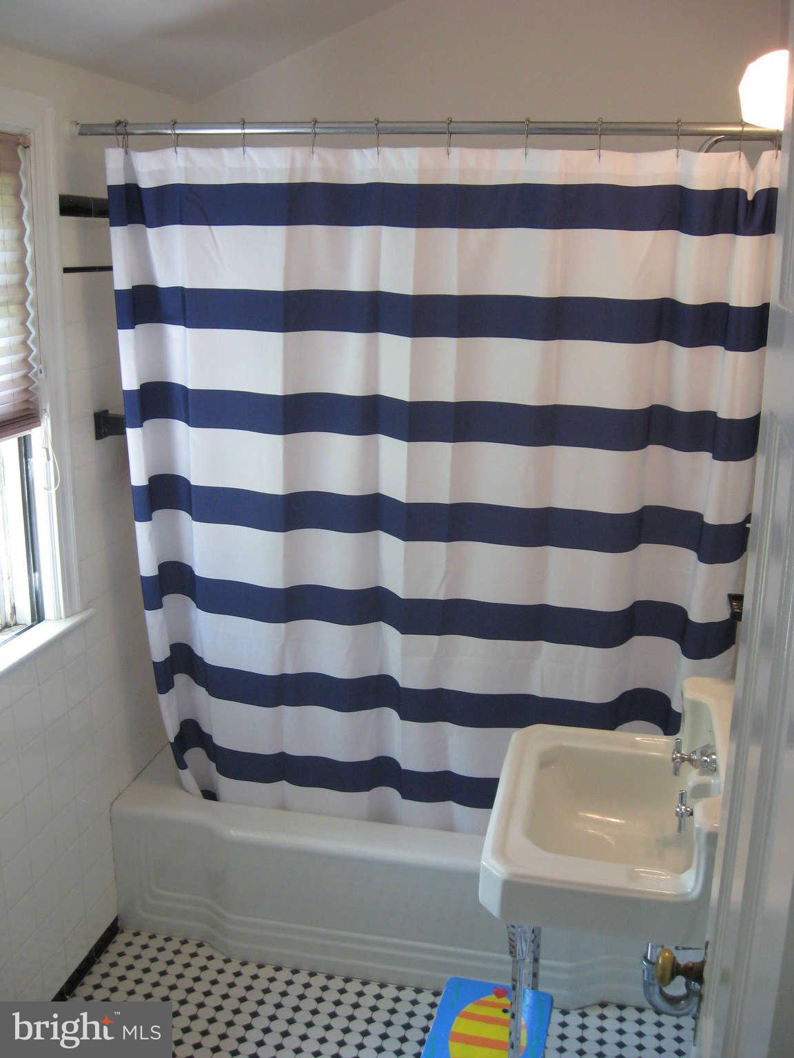 9015 Bradford Road Silver Spring, MD 20901 - Photo 14 of 25 a bathroom with a sink a toilet and a mirror