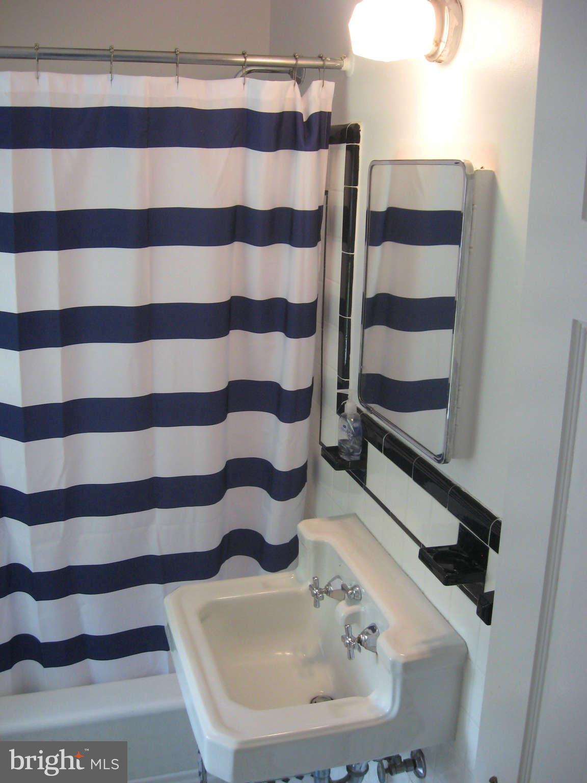 9015 Bradford Road Silver Spring, MD 20901 - Photo 15 of 25 a bathroom with a sink and a mirror
