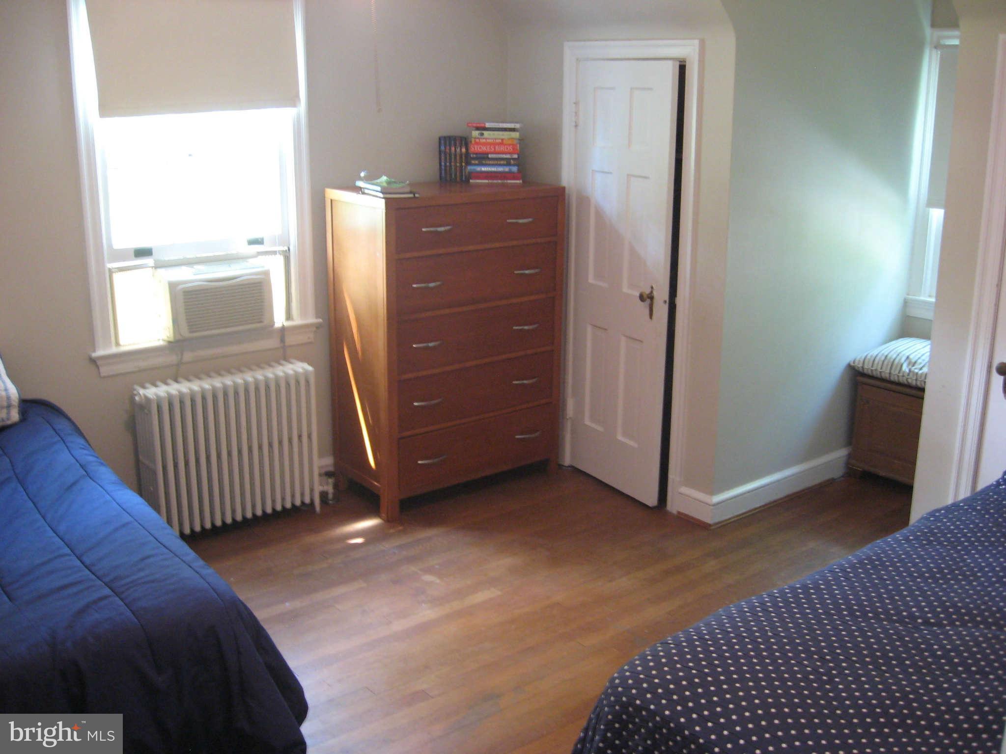 9015 Bradford Road Silver Spring, MD 20901 - Photo 16 of 25 a bedroom with a bed and wooden floor