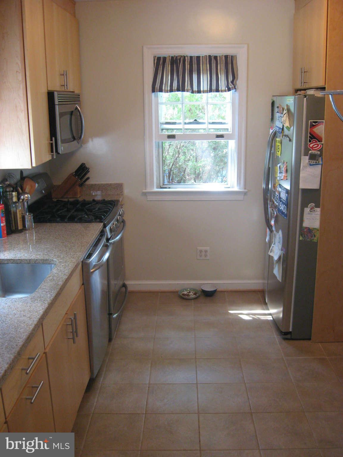 9015 Bradford Road Silver Spring, MD 20901 - Photo 3 of 25 a kitchen with stainless steel appliances granite countertop a refrigerator and a sink