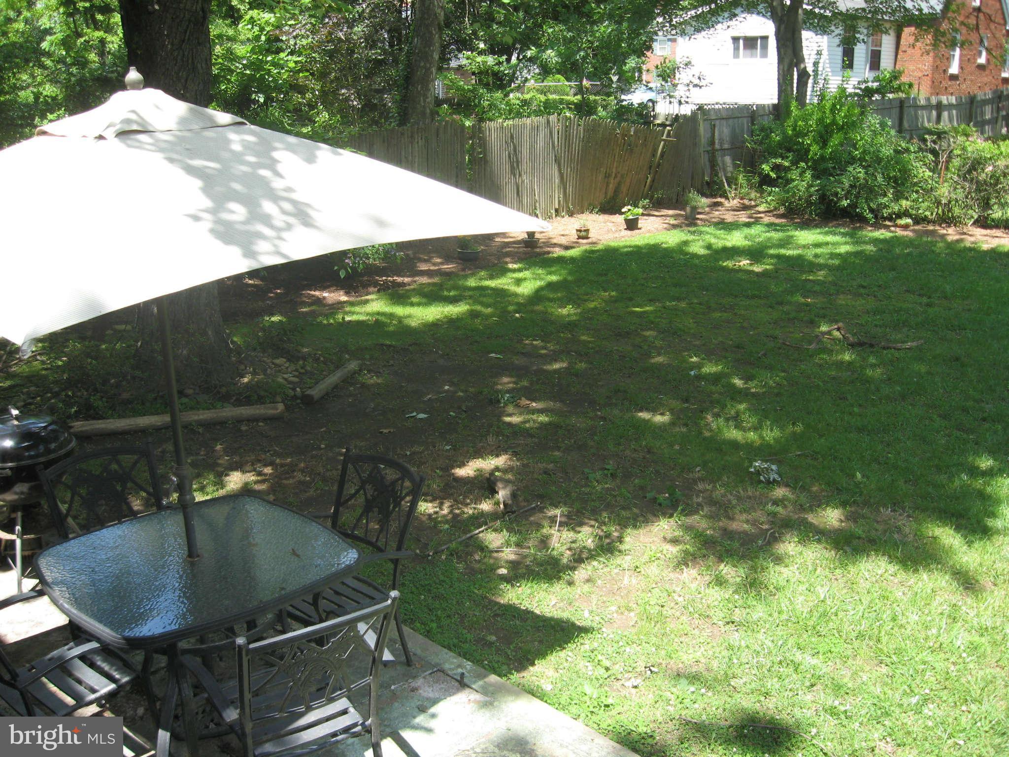 9015 Bradford Road Silver Spring, MD 20901 - Photo 24 of 25 a backyard of a house with table and chairs