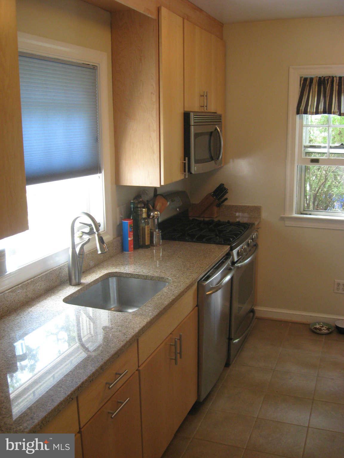9015 Bradford Road Silver Spring, MD 20901 - Photo 4 of 25 a kitchen with a sink and a stove top oven