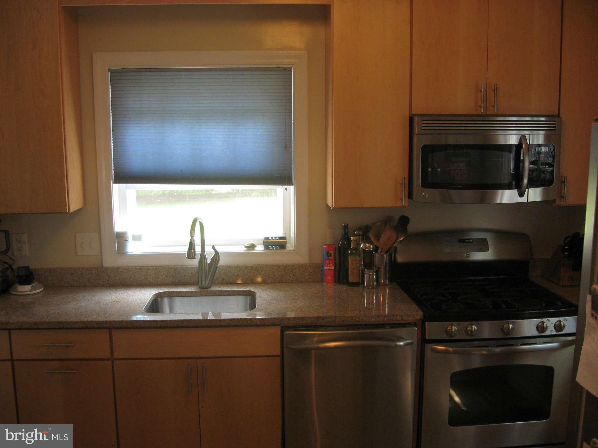 9015 Bradford Road Silver Spring, MD 20901 - Photo 5 of 25 a kitchen with a sink stove and microwave