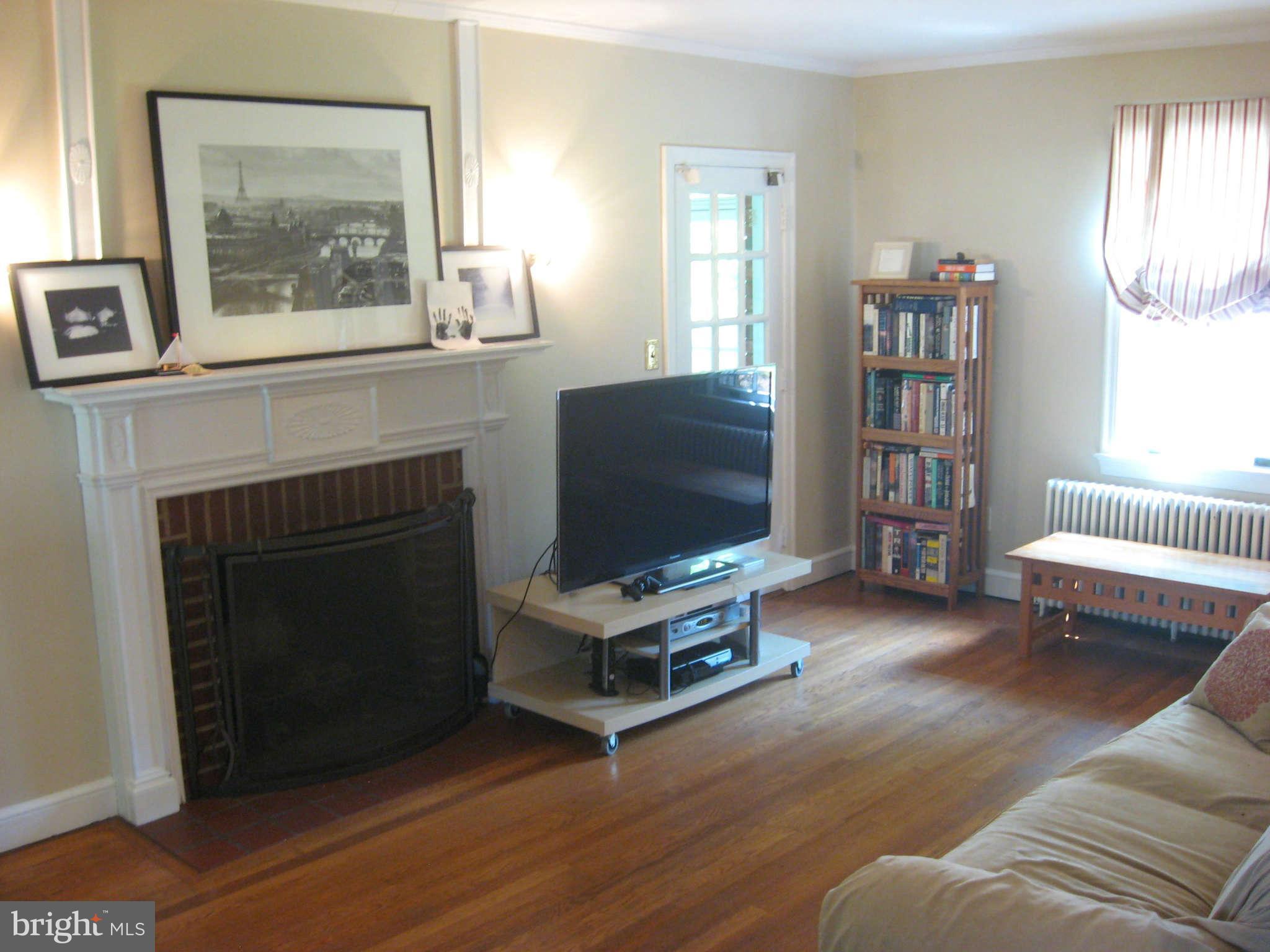 9015 Bradford Road Silver Spring, MD 20901 - Photo 7 of 25 a living room with furniture and a fireplace