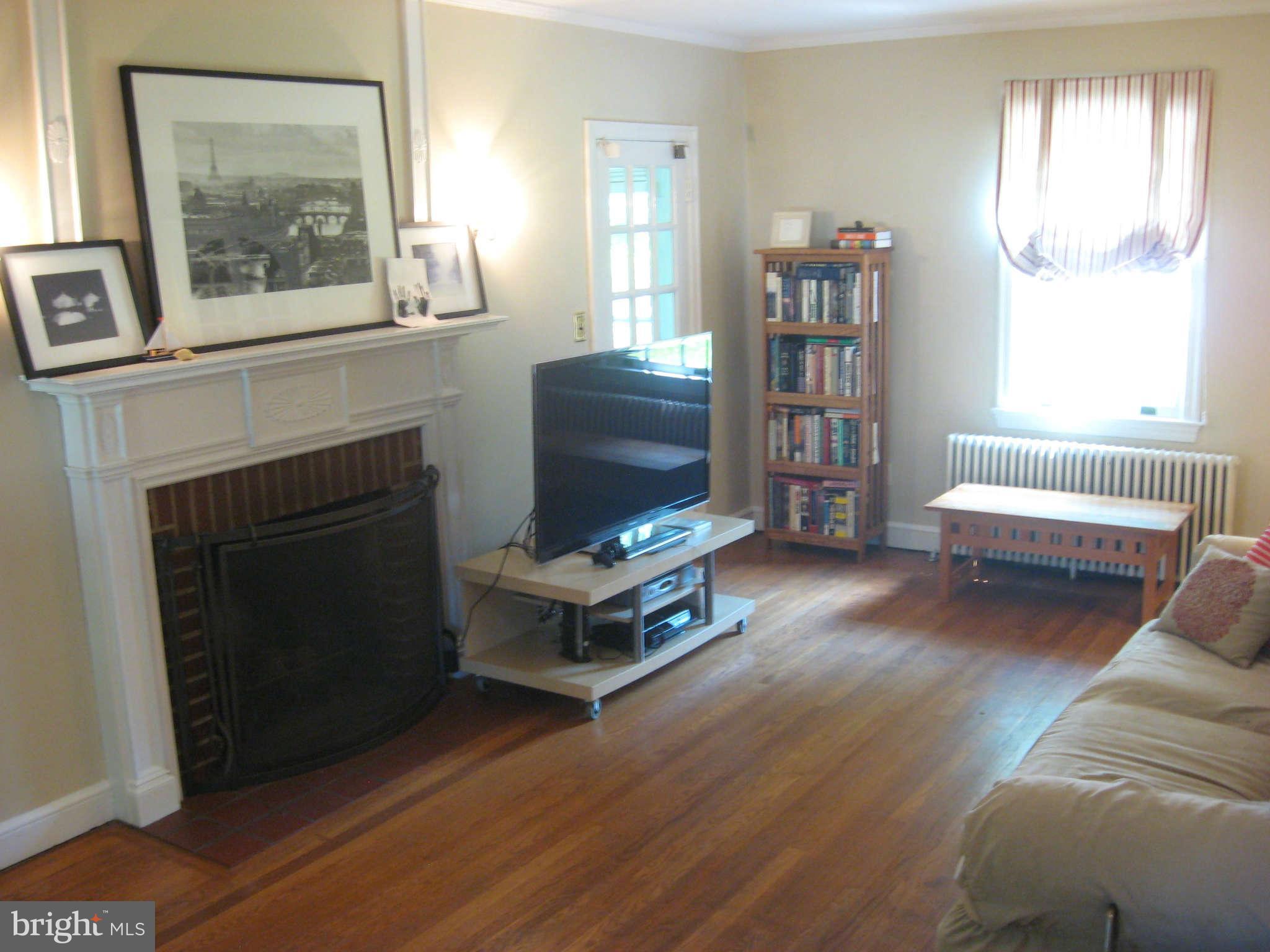 9015 Bradford Road Silver Spring, MD 20901 - Photo 8 of 25 a living room with furniture and a fireplace