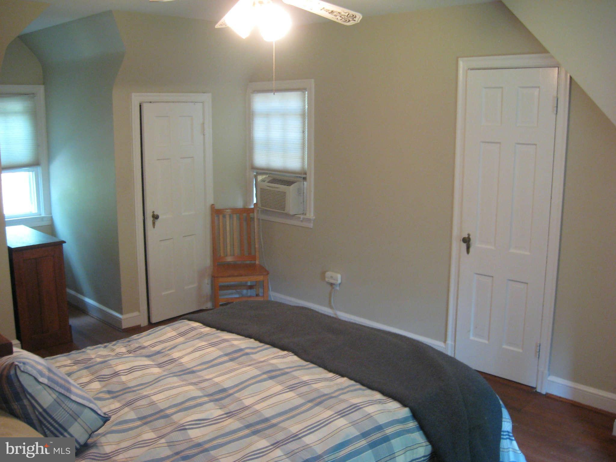 9015 Bradford Road Silver Spring, MD 20901 - Photo 10 of 25 a bedroom with a bed and wooden floor