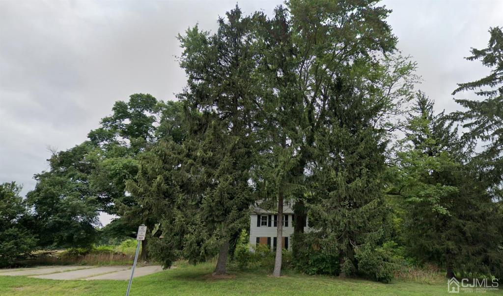 a sign board with a tree in the background