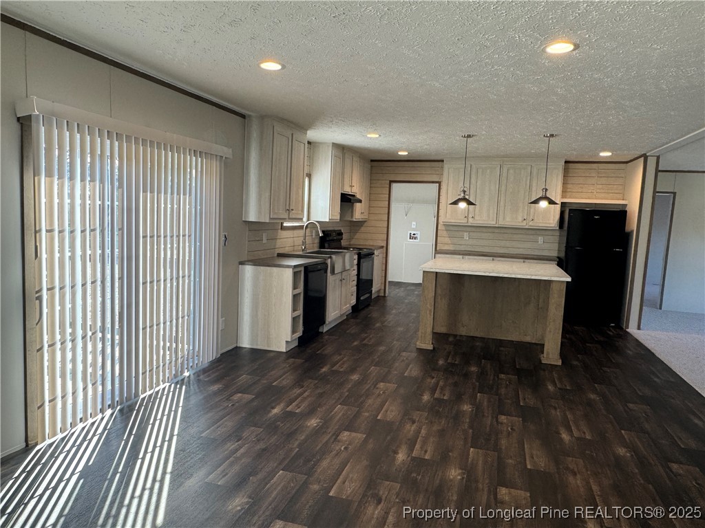 280 Cain Road St. Pauls, NC 28384 - Photo 11 of 23 a living room with stainless steel appliances kitchen island granite countertop furniture a refrigerator a sink a stove and white cabinets