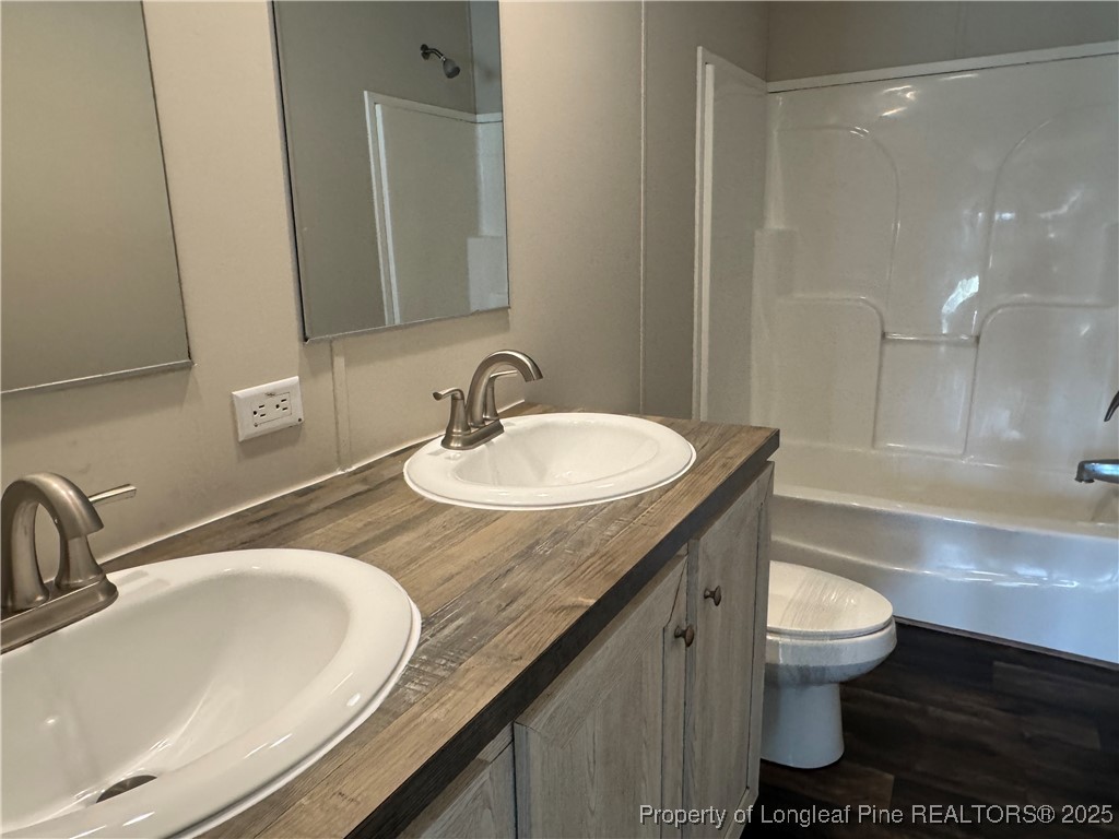 280 Cain Road St. Pauls, NC 28384 - Photo 20 of 23 a bathroom with a granite countertop sink a toilet and a mirror