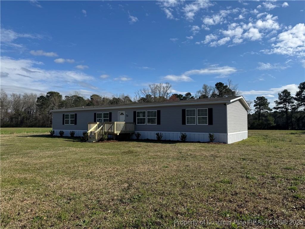 280 Cain Road St. Pauls, NC 28384 - Photo 3 of 23 a view of a house with a yard