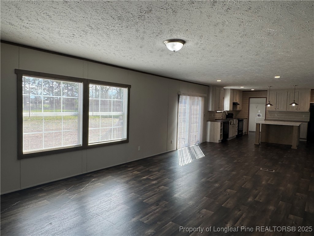 280 Cain Road St. Pauls, NC 28384 - Photo 10 of 23 an empty room with wooden floor and windows