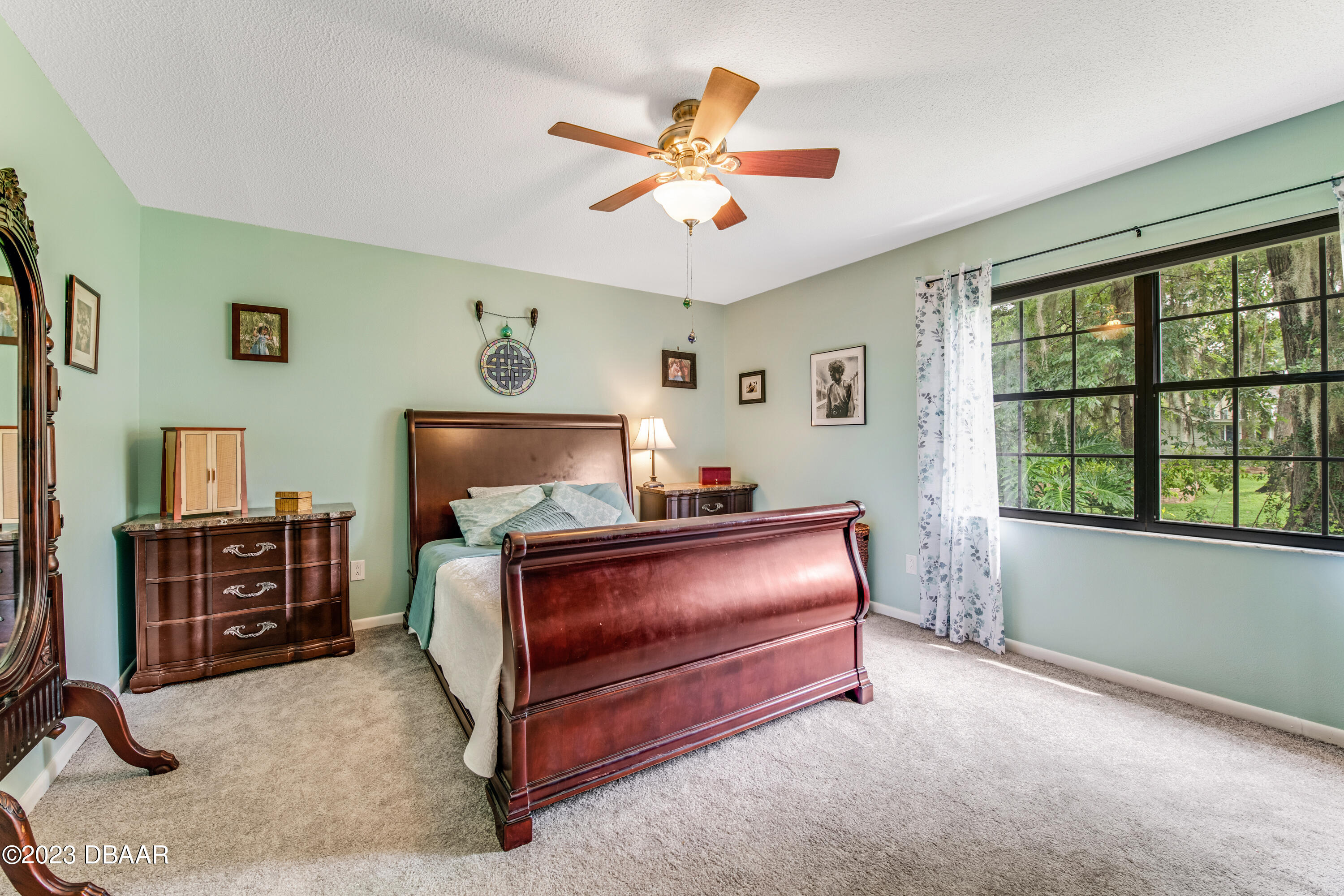 11 Eagle Drive Ormond Beach, FL 32174 - Photo 14 of 25 a bed room with a bed and a ceiling fan