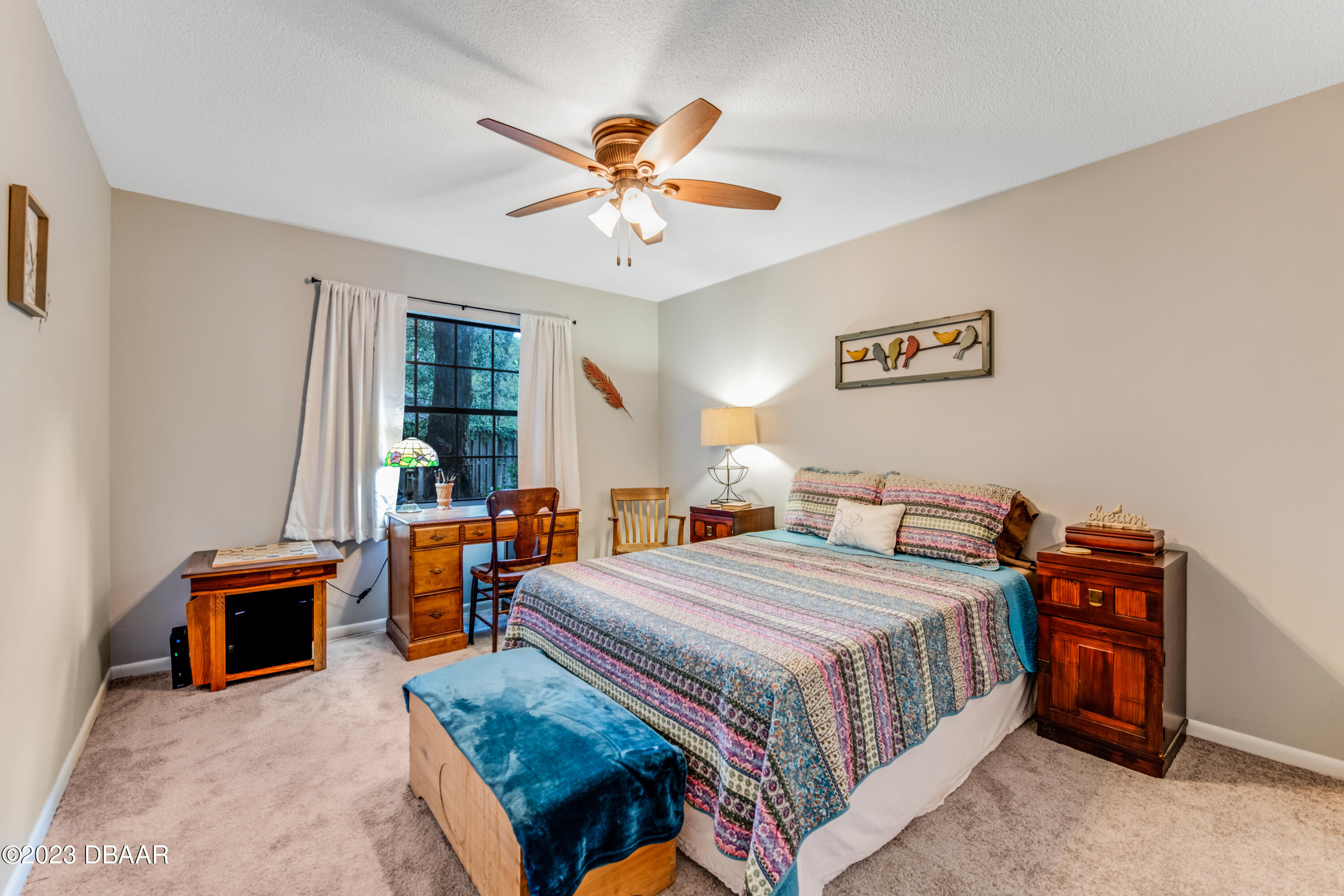 11 Eagle Drive Ormond Beach, FL 32174 - Photo 18 of 25 a bedroom with a bed and a chandelier
