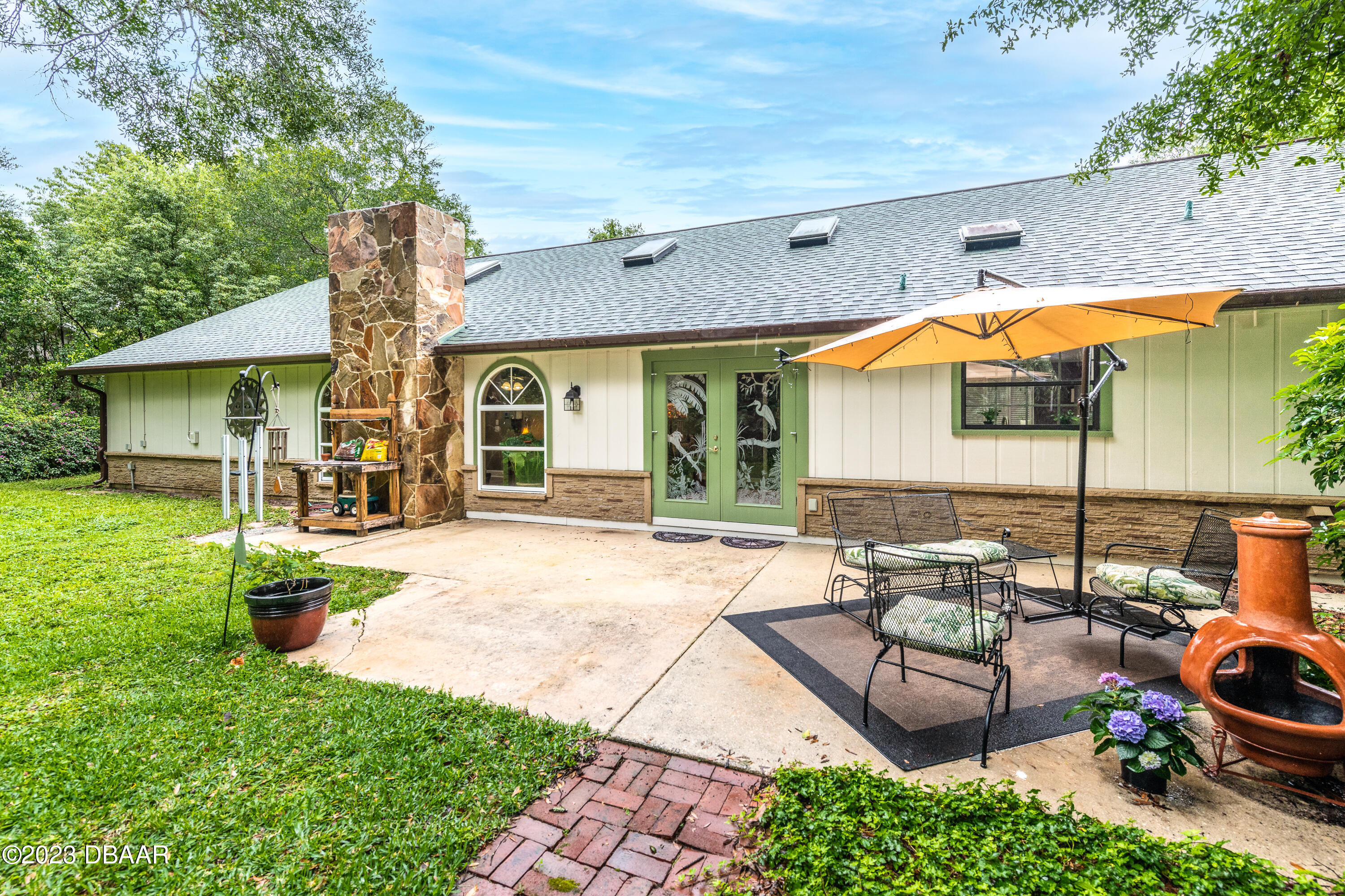 11 Eagle Drive Ormond Beach, FL 32174 - Photo 20 of 25 a view of a house with backyard porch and sitting area