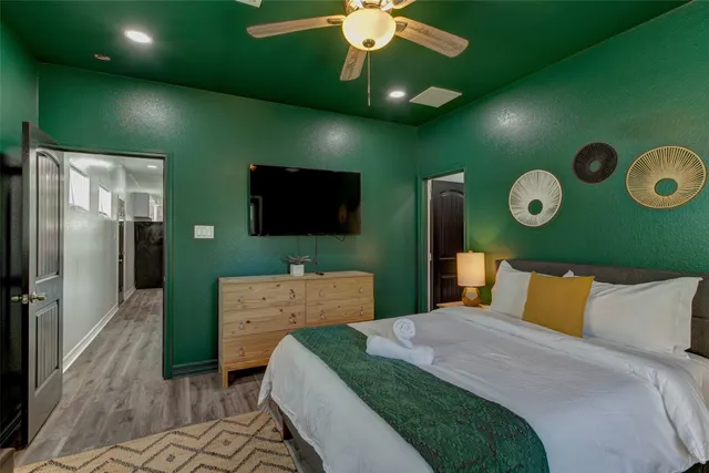 a bedroom with a bed and a television