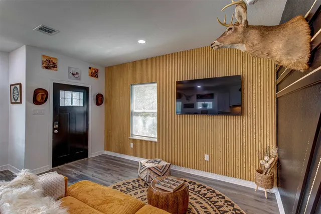 a bedroom with a bed and a flat screen tv