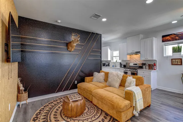 a living room with furniture and a rug