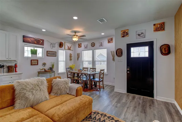 a living room with furniture and wooden floor