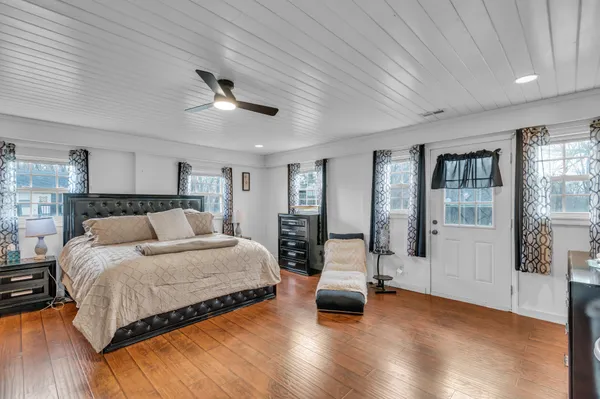 a spacious bedroom with a bed and a chandelier