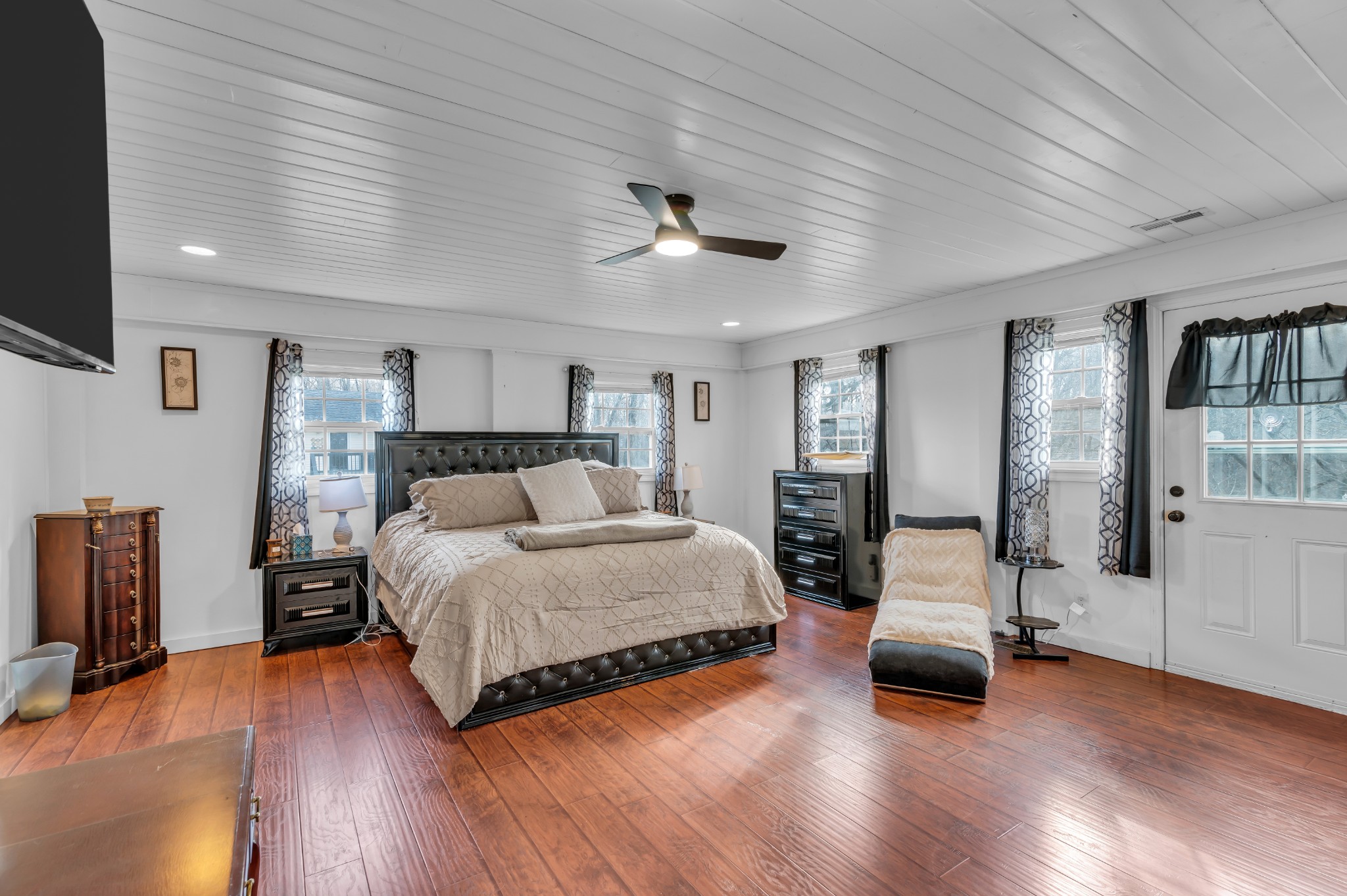 672 Old Snow Hill Road Dowelltown, TN 37059 - Photo 28 of 54 a spacious bedroom with a large bed and a chandelier