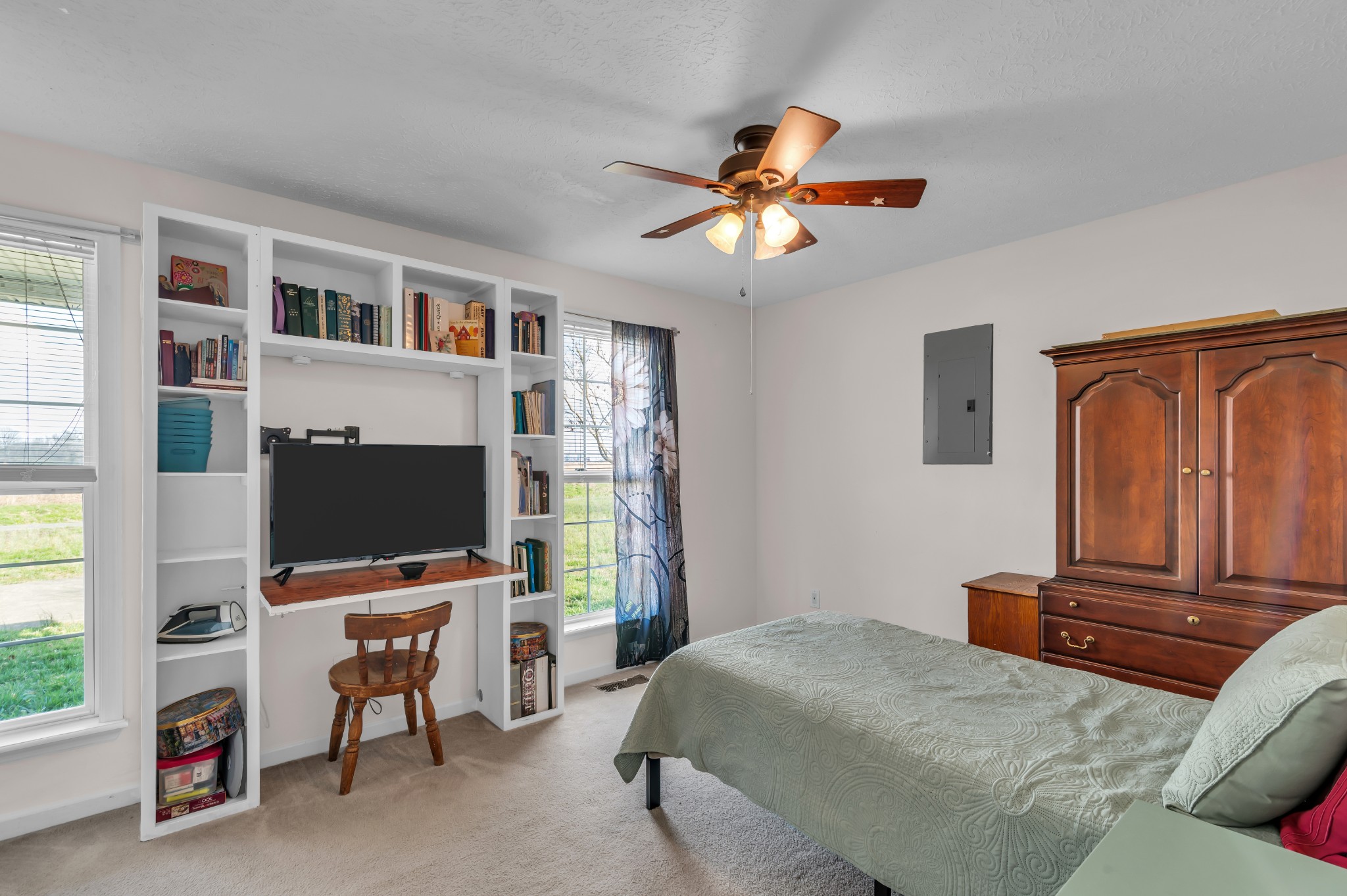672 Old Snow Hill Road Dowelltown, TN 37059 - Photo 32 of 54 a bedroom with a bed and a flat screen tv