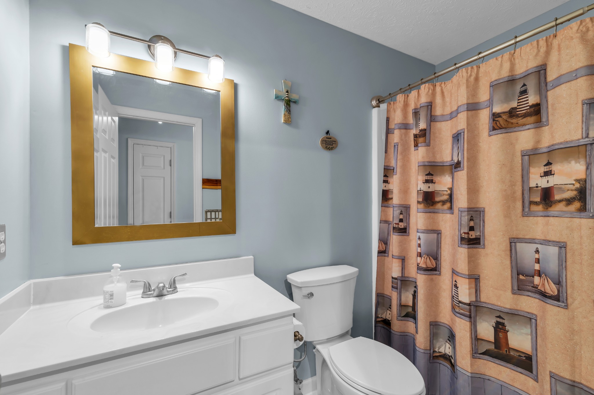 672 Old Snow Hill Road Dowelltown, TN 37059 - Photo 33 of 54 a bathroom with a sink a toilet and shower curtain