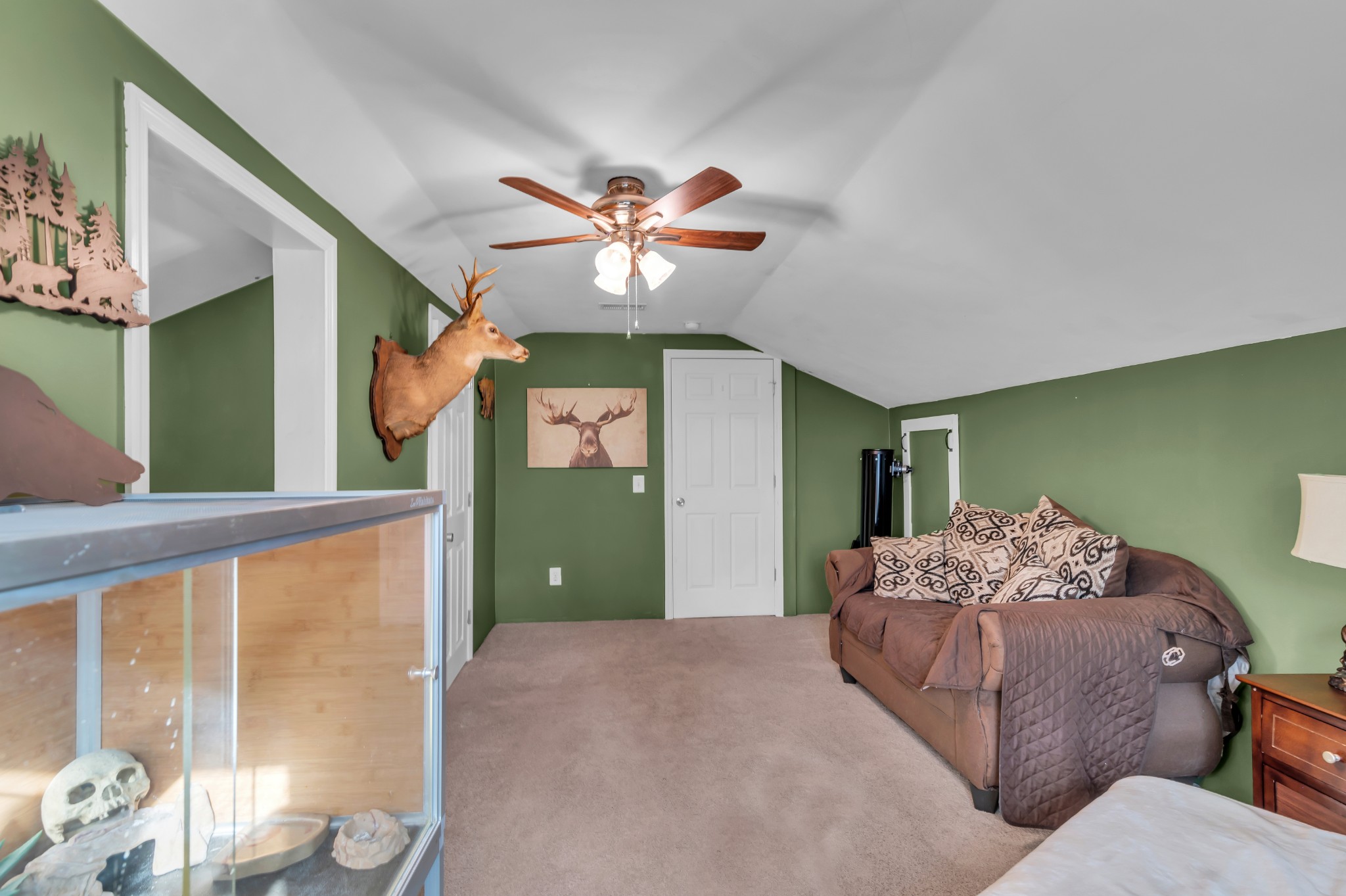 672 Old Snow Hill Road Dowelltown, TN 37059 - Photo 35 of 54 a living room with a bed furniture and a chandelier