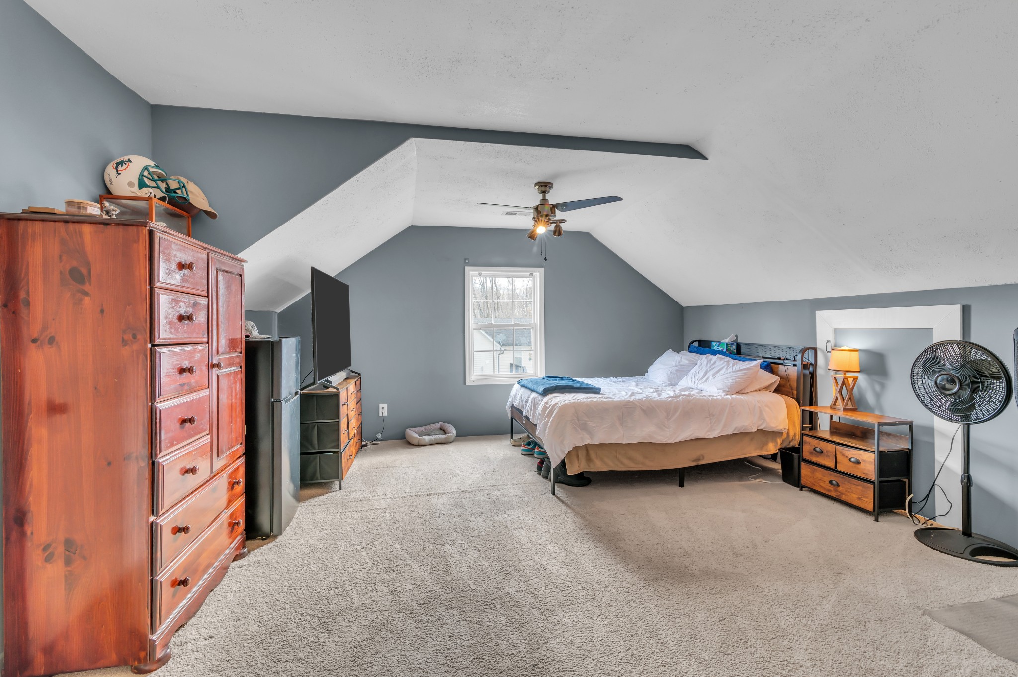 672 Old Snow Hill Road Dowelltown, TN 37059 - Photo 37 of 54 a spacious bedroom with a bed and a chandelier