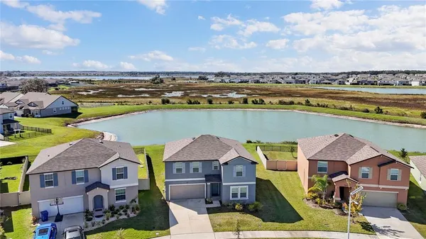 an aerial view of a house with a lake view