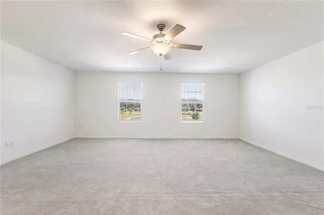 an empty room with fan and window