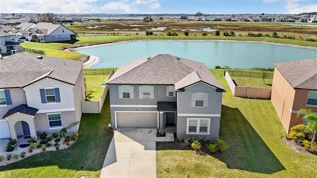 an aerial view of a house with a lake view