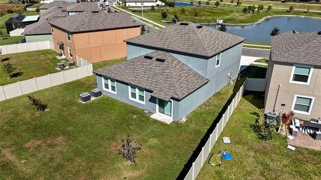 an aerial view of multiple houses with a yard