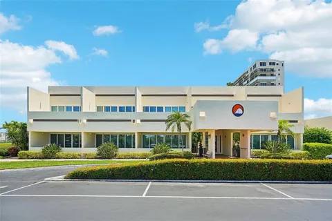an open kitchen with kitchen island a stove and a refrigerator