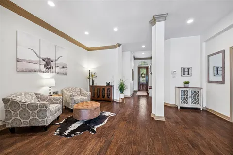 a living room with furniture and wooden floor
