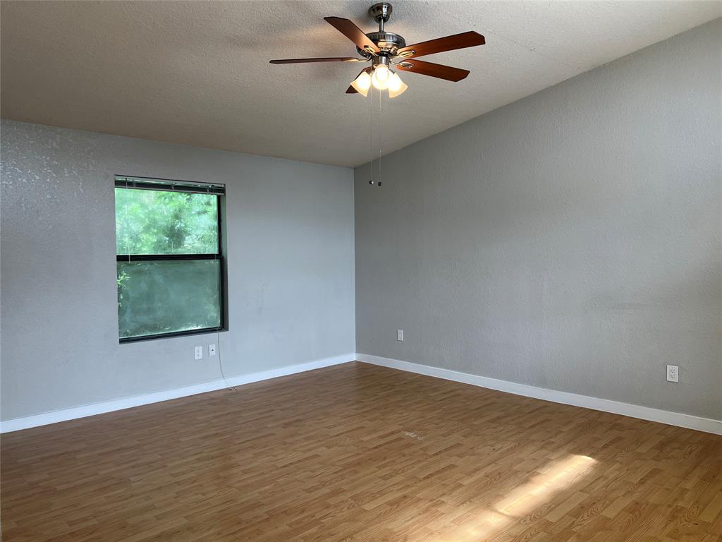 701 West Sycamore Street, Unit 303 Denton, TX 76201 - Photo 3 of 12 This living room has a large window, lighted ceiling fan, and lovely floors.