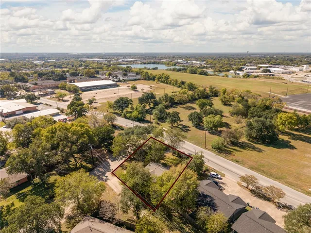 an aerial view of residential houses with outdoor space