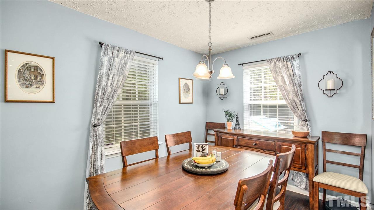 5720 Forest Point Road Raleigh, NC 27610 - Photo 6 of 22 a view of a dining room with furniture window and wooden floor