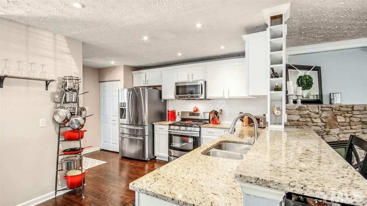 5720 Forest Point Road Raleigh, NC 27610 - Photo 8 of 22 a kitchen with stainless steel appliances granite countertop a refrigerator and a sink