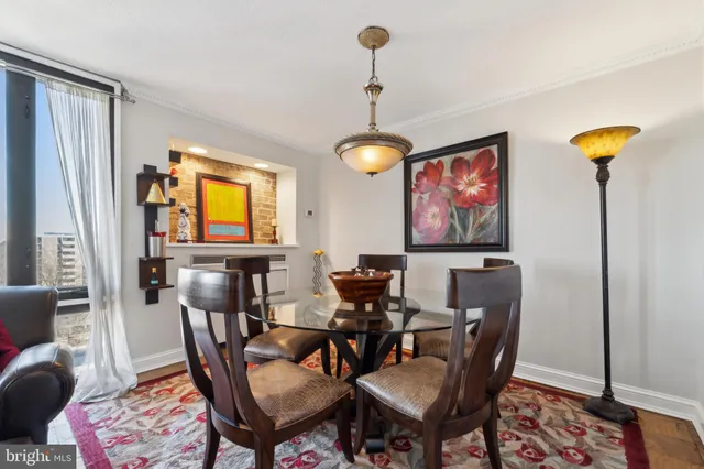 a view of a a dining room with furniture window and wooden floor